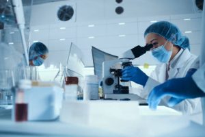 Young team during virus lab tests. Multi ethnic scientists focused on work. Wearing protective workwear